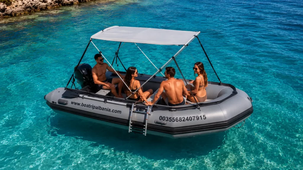 4 person inflatable boat for rent in Himare, Albania, anchored in crystal clear turquoise water.
